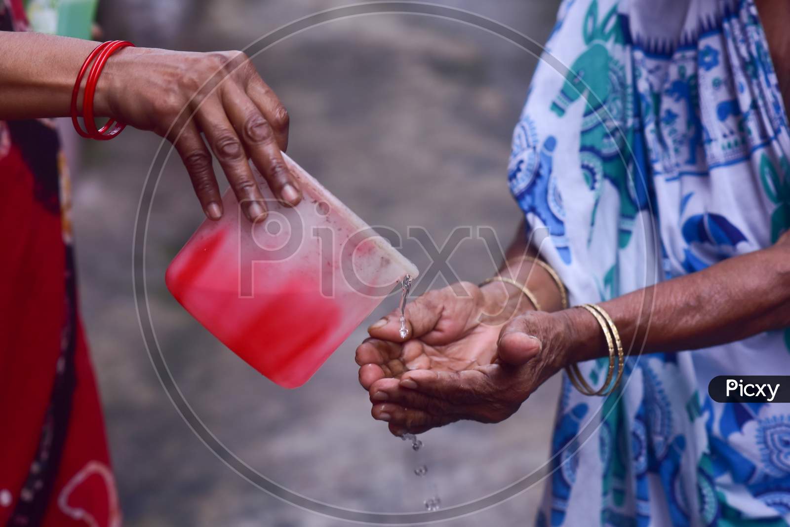 An old indian woman praying to god to seek blessing  for the coronavirus
