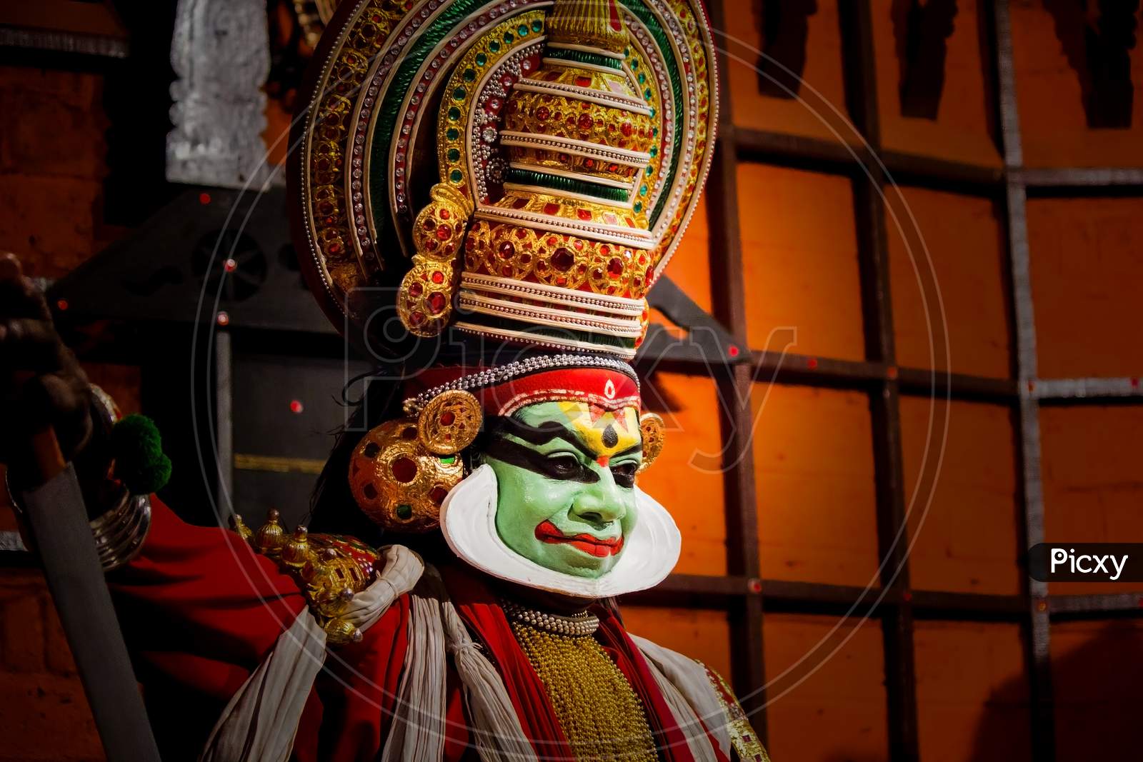 Kochi, India - March 15, 2014: An Indian Classical Dance Form Named Kathakali Artists Tells Indian Mythological Stories Through Numerous Gestures Techniques And Emotions In Front Of Several European Tourists.