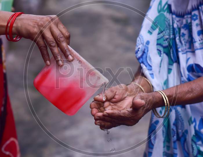 An old indian woman praying to god to seek blessing  for the coronavirus