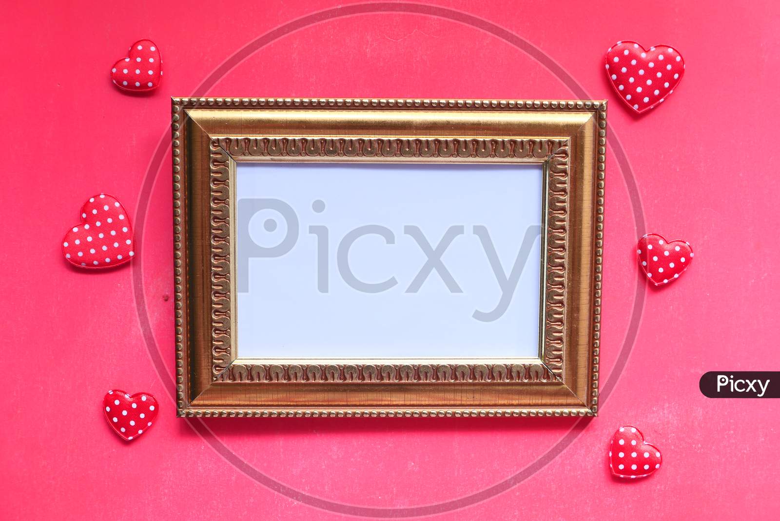Empty Picture Frame With Heart Shape On Red Background