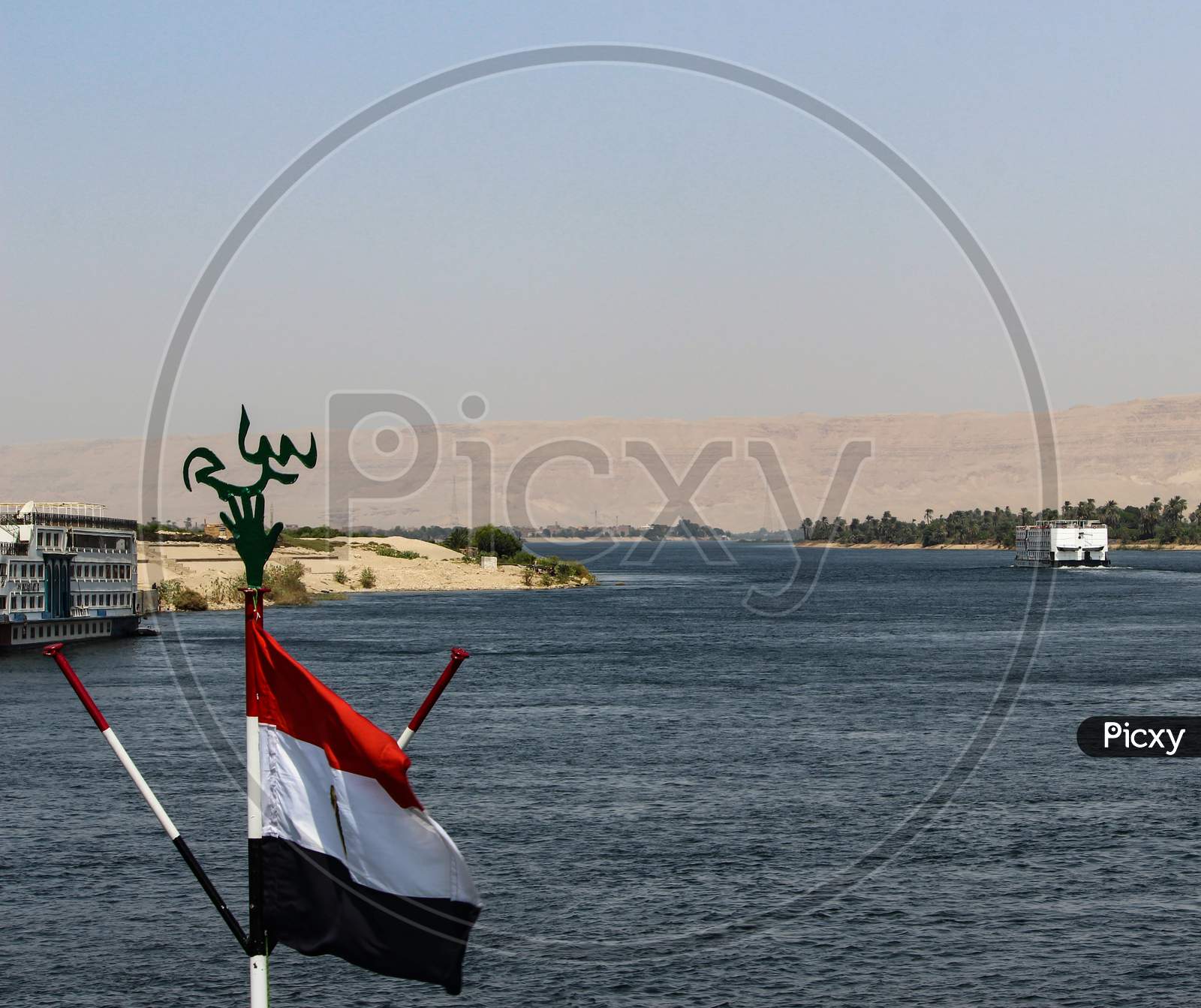 Flag Of Egypt Waving From The Boat On Nile River.
