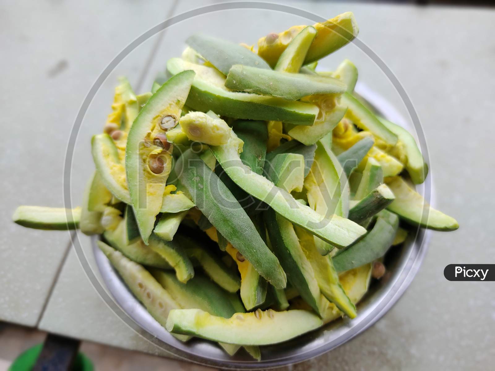 pointed gourd green vegetable cut into pieces kept in a bowl