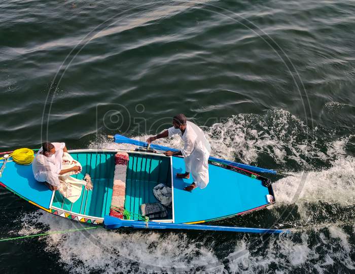 Egyptian Boys Selling Handmade Cloth While Sailing On Boat.