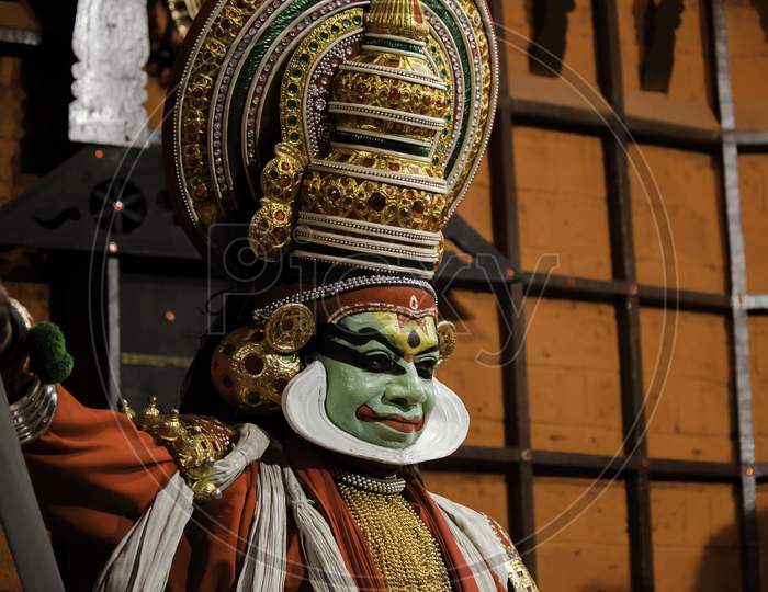 Kochi, India - March 15, 2014: An Indian Classical Dance Form Named Kathakali Artists Tells Indian Mythological Stories Through Numerous Gestures Techniques And Emotions In Front Of Several European Tourists.