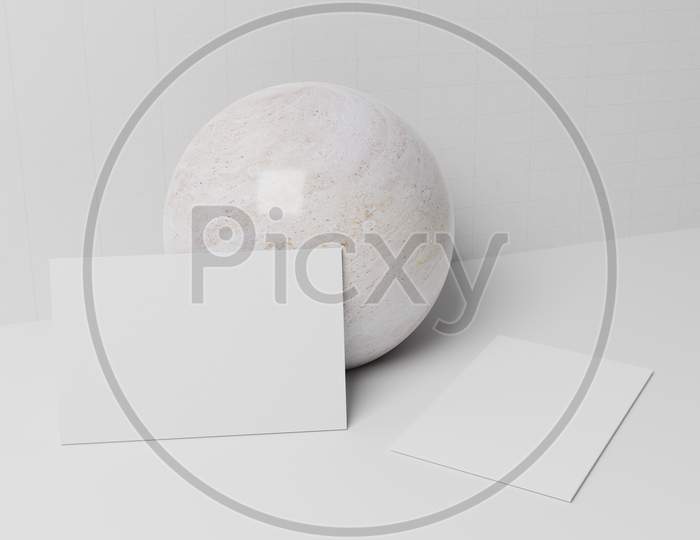 White Business Card Paper Mockup Lean On Marble Sphere With Blank Space Cover For Insert Company Logo Or Personal Identity On Cardboard Background. Modern Stationary Concept. 3D Illustration Render