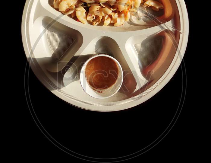 Cooked Macaroni with elbow pasta  an cheese with tea and tomato sauce indian breakfast on dark background