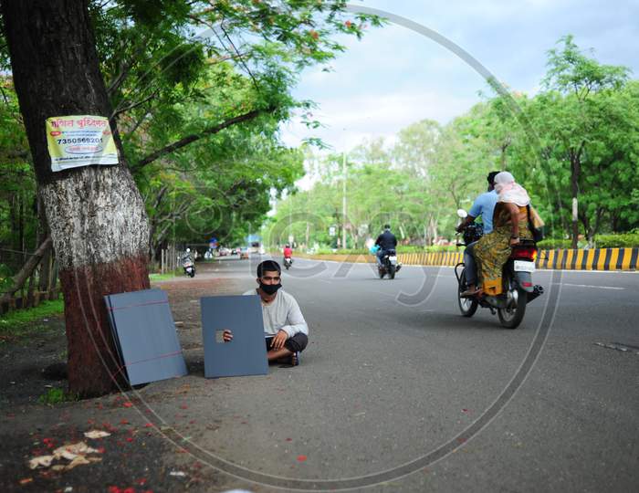 Youth selling plastic mudguards by roadside