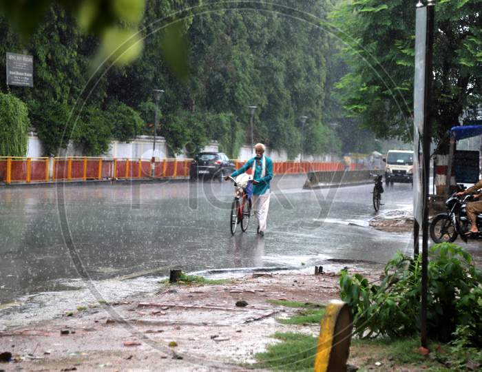 A Man Walk On The Road During a Heavy Pre Monsoon Rain In Prayagraj, June 17, 2020.