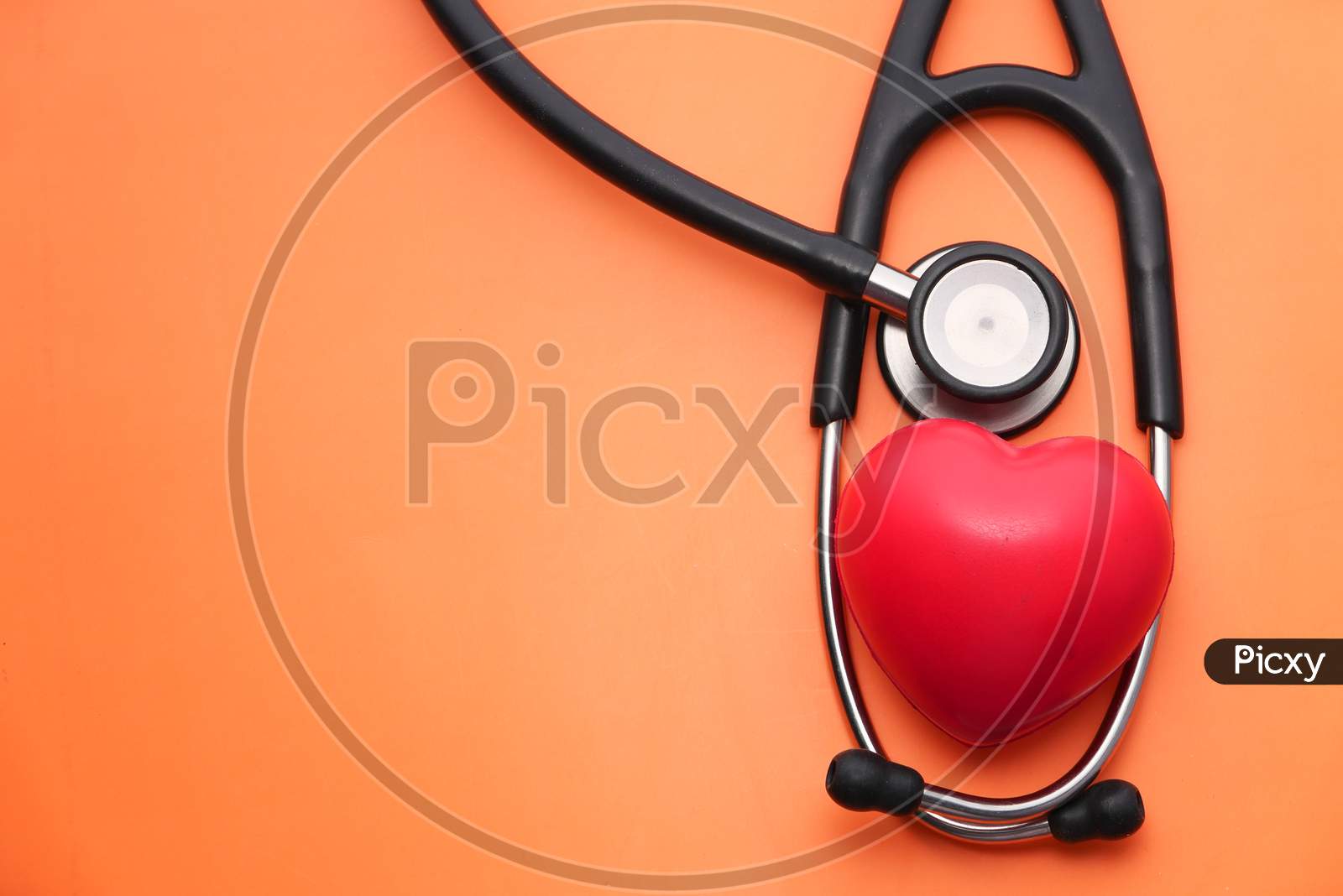 Heart Shape Symbol And Stethoscope On Purple Background