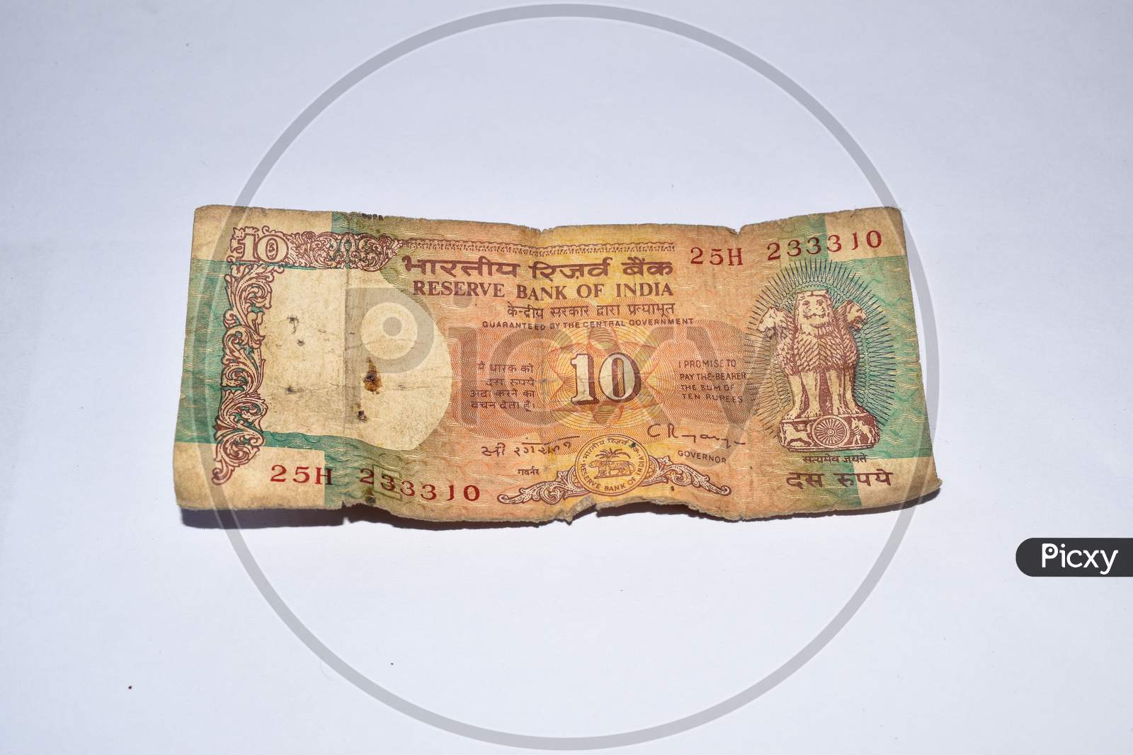 Old 10 Rupees Indian Currency Note On White Background.