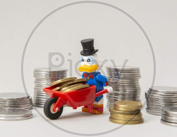 Scrooge Mcduck Carrying Coins On A Wheelbarrow On White Background