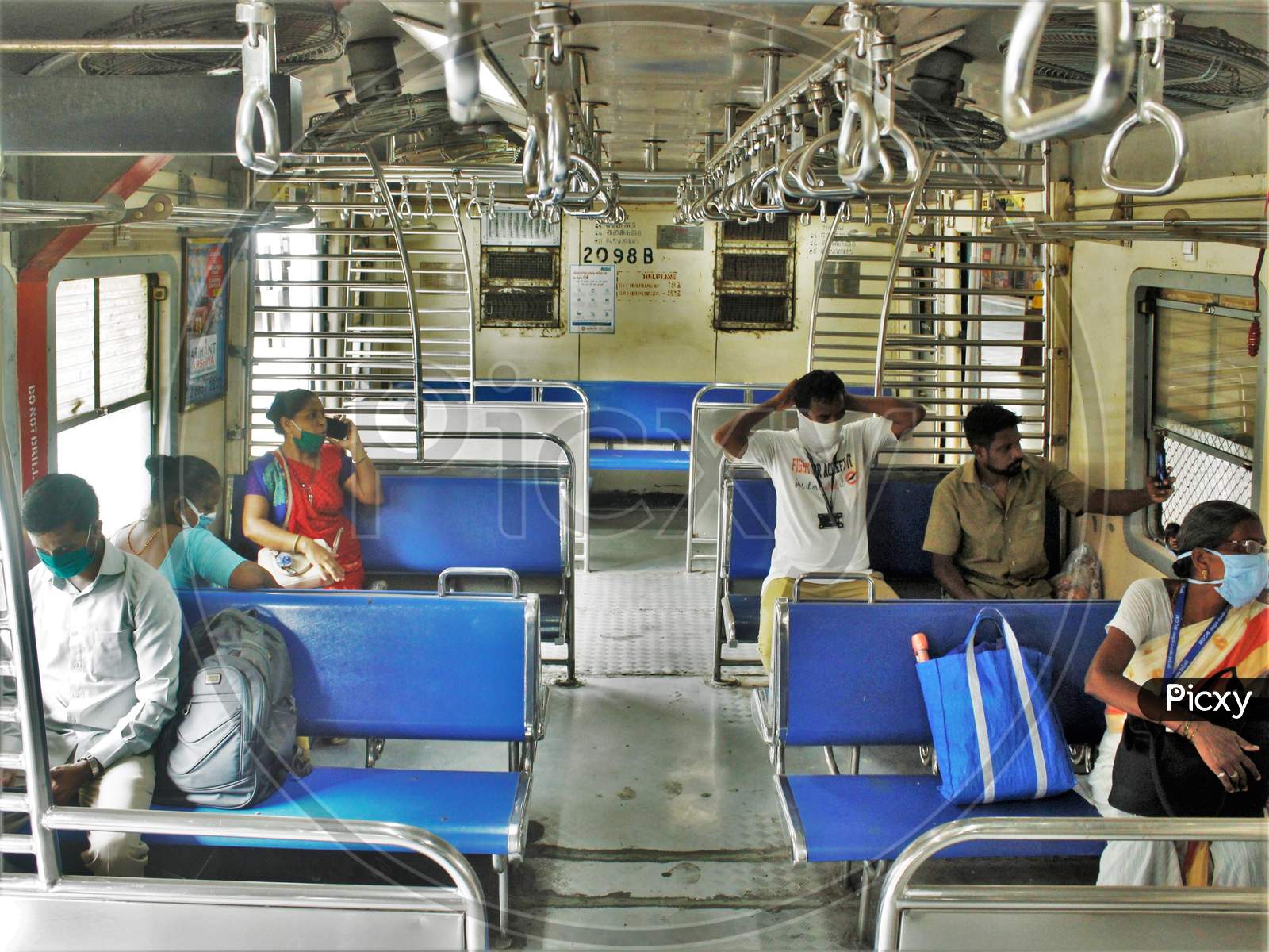 Passengers sit inside the train scheduled for essential service workers after the government eased a nationwide lockdown which was imposed as a preventive measure against the COVID-19 coronavirus, at CST local train station, in Mumbai, India, on June 15, 2020.