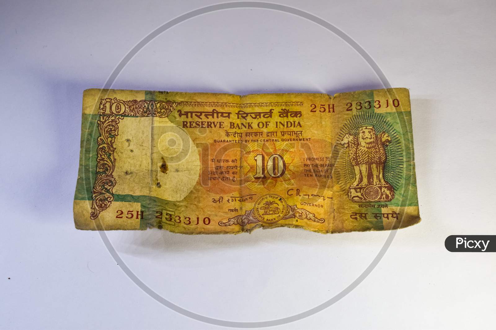 Old 10 Rupees Indian Currency Note On White Background.