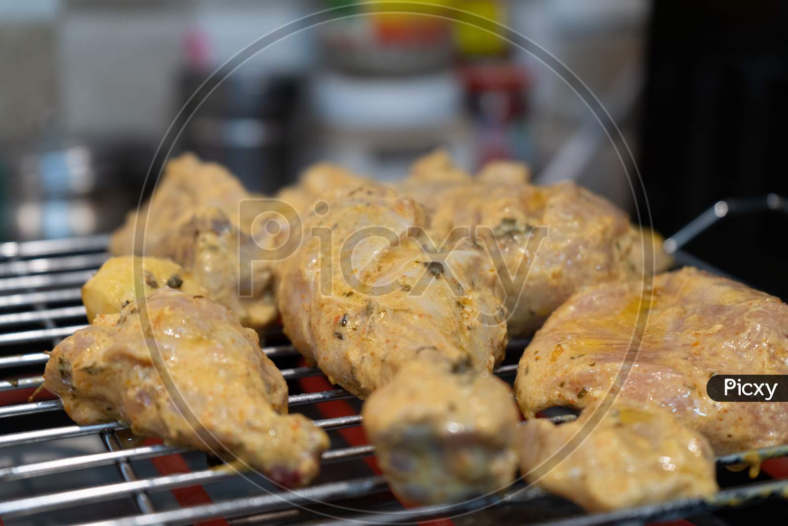 Chicken Marinated With Oil And Spices Cooking On A Hot Electric Grill Making Paneer Tikka Masala In An Indian Home