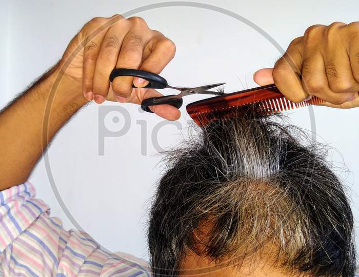 A man self cutting hair due to covid-19 pandemic.