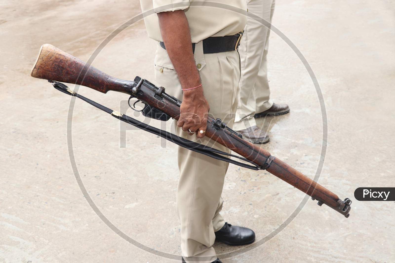 Indian Police Officer Holding The Big Gun