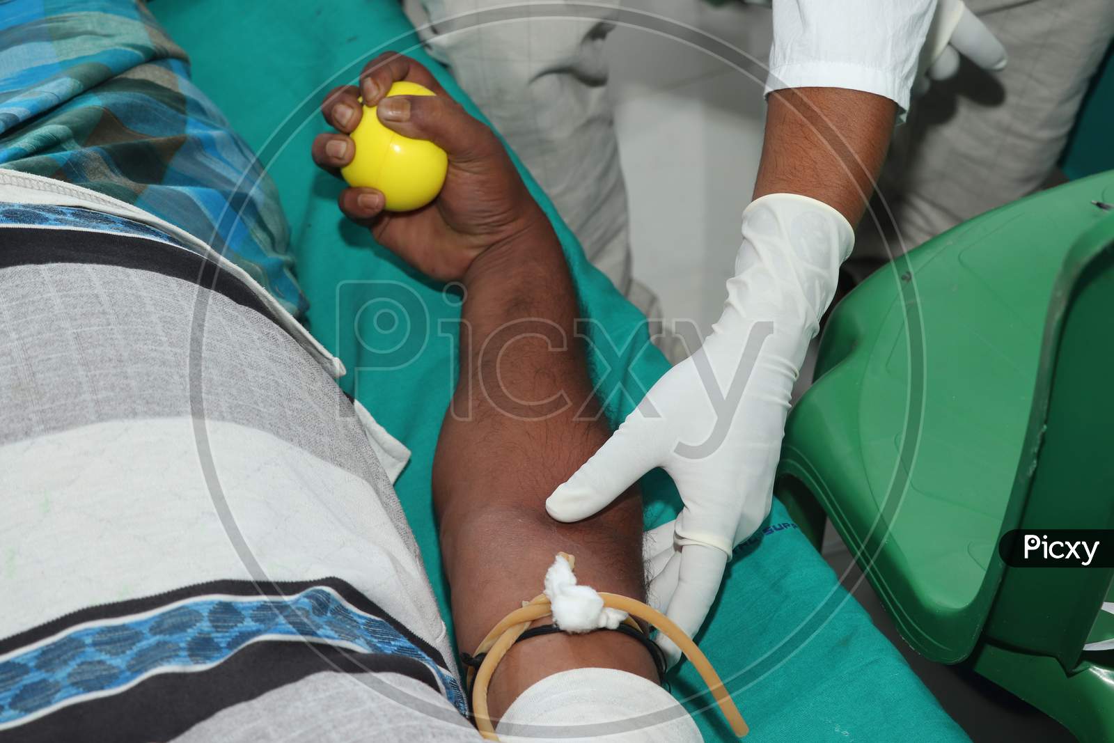 Blood Donor At Donation With A Bouncy Ball Holding In Hand Stock Photo