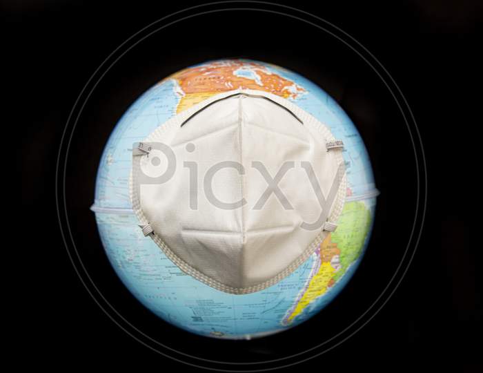 Planet Earth With Face Mask To Protect Against Viruses. World Corona Virus Concept.