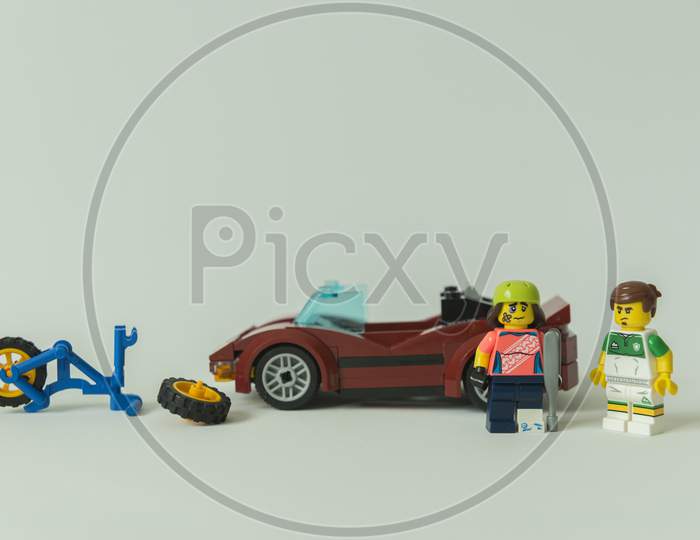 Minifigure Of Cyclist And Car Driver Next To The Bicycle Accident.