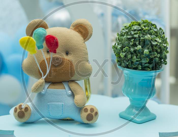 Boy Party Decoration With Teddy Bear Holding Colorful Balloons.