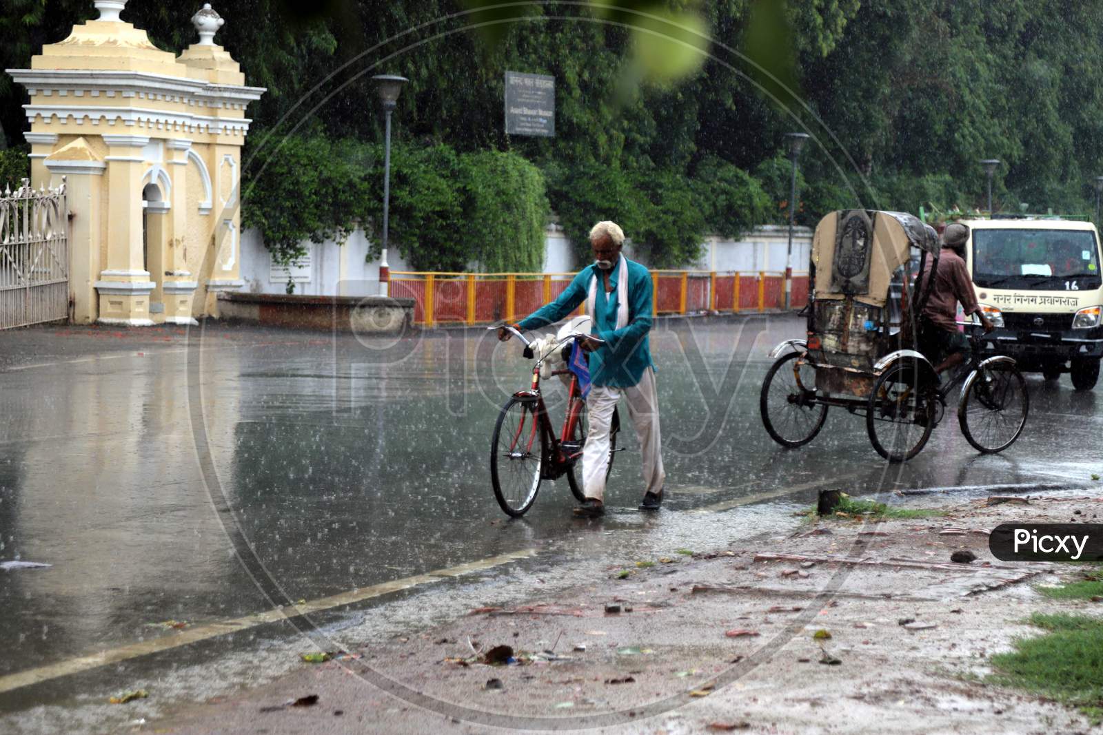 A Man walks On The Road During a Heavy Pre Monsoon Rain In Prayagraj, June 17, 2020.
