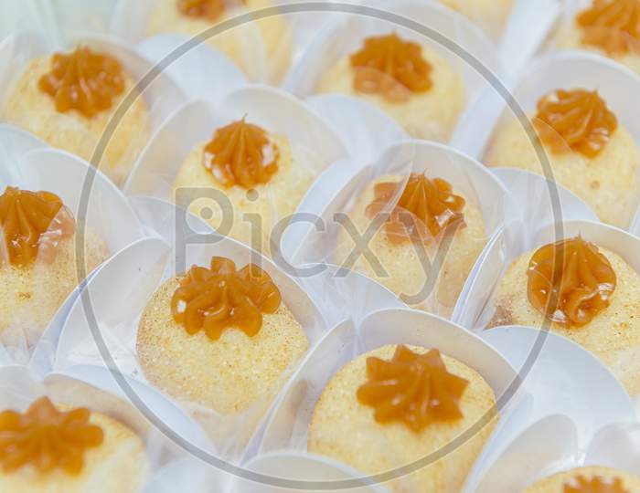 Top View Of Delicious Coconut Candies Icing Caramel.