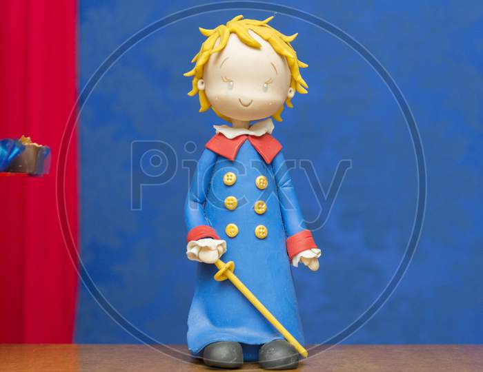 Kids Birthday Party Decoration. Little Prince Theme Party. Closeup Of Little Prince In Your Small Planet On Blue Background.