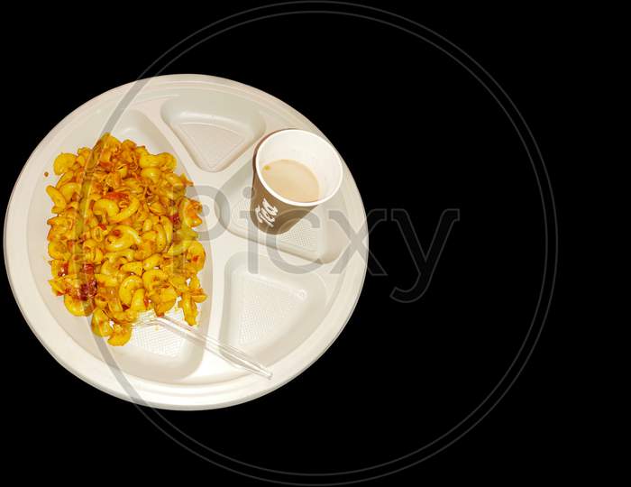 Cooked Macaroni with elbow pasta  an cheese with tea and tomato sauce indian breakfast on dark background