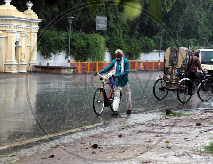A Man walks On The Road During a Heavy Pre Monsoon Rain In Prayagraj, June 17, 2020.