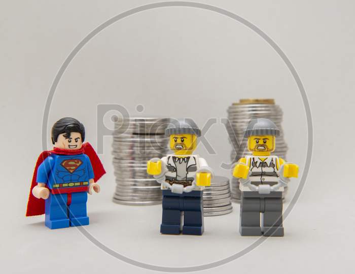 Superman Arresting Two Money Thieves.
