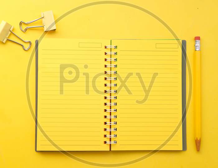 High Angle View Of Yellow Color Notepad Yellow Desk