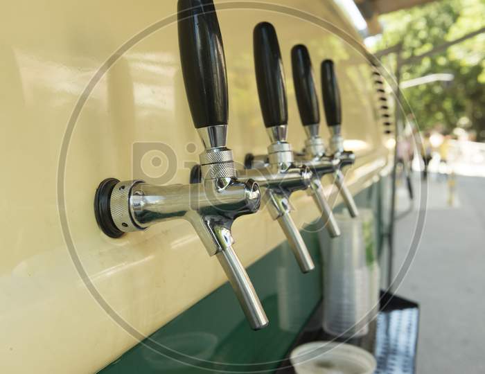 The Beer Taps In A Side Of A Vintage Van.
