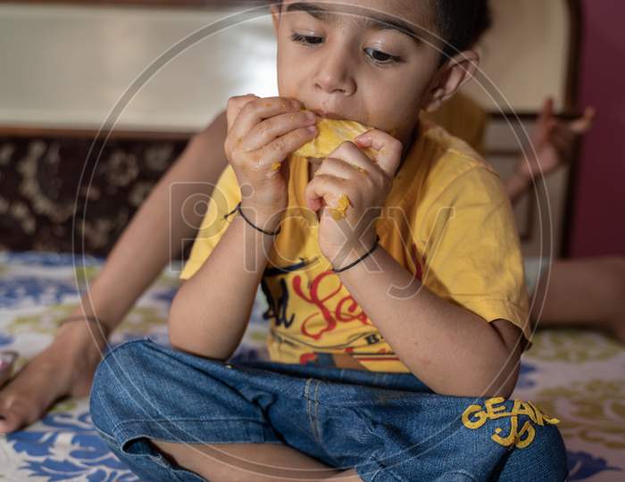 jaipur . Rajasthan . India - June 12, 2020. Happy little boy eating mango(lockdown activities)