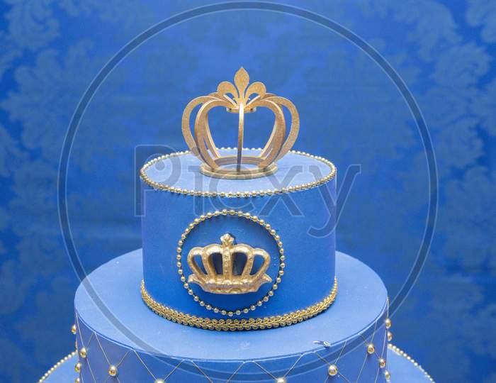 Fake Blue Birthday Cake With A Crown On Top. Little Prince Or Royal Theme. Decorated Table For Child Birthday Celebration. Close Up Of Decor Party.