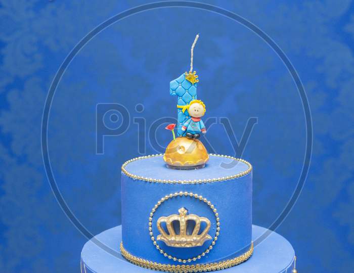 Number One Candle On A Blue Background. Little Prince Theme. Fake Birthday Cake With Personalized Candle For First Birthday For Boy.