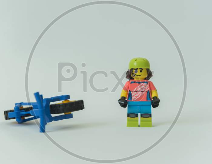 Injured Cyclist Minifigure With Broken Leg Next To His Bike