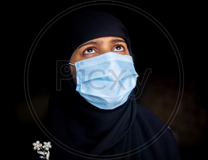 An Asian Muslim Girl Wearing A Surgical Mask For Coronavirus Protection. Hijab Woman Wearing A Mask For Safety. Portrait Views.