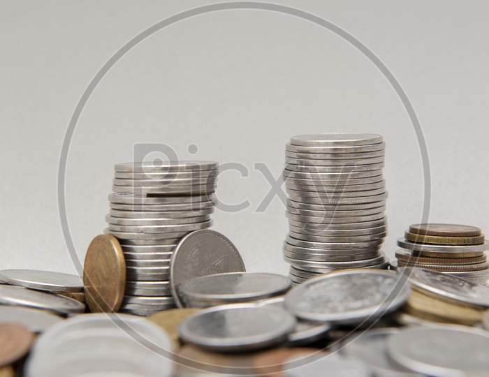Stack Of Coins With White Background. Selective Focus.