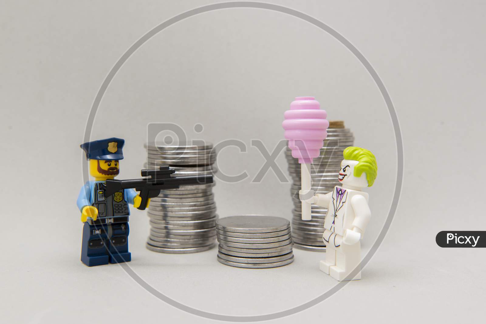 Policeman Aiming His Firearm At The Joker Next To A Pile Of Coins.