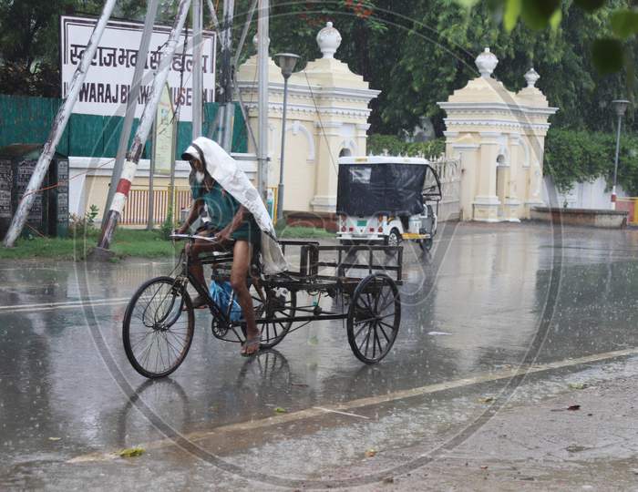 A Man Pedals his Trolly On The Road During a Heavy Pre Monsoon Rain In Prayagraj, June 17, 2020.