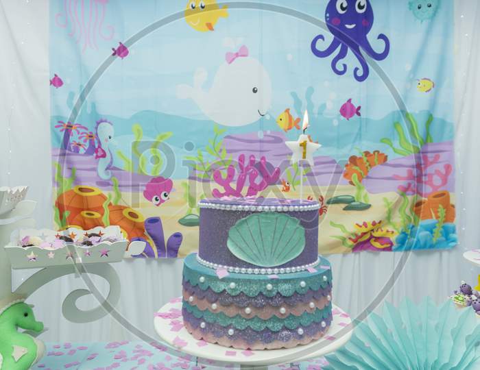 Cake Table Overview Decorated With The Seabed Theme. Children'S Party With Octopus, Seahorse, Oysters, Corals And Colorful Balloons. Party And Fun Concept.
