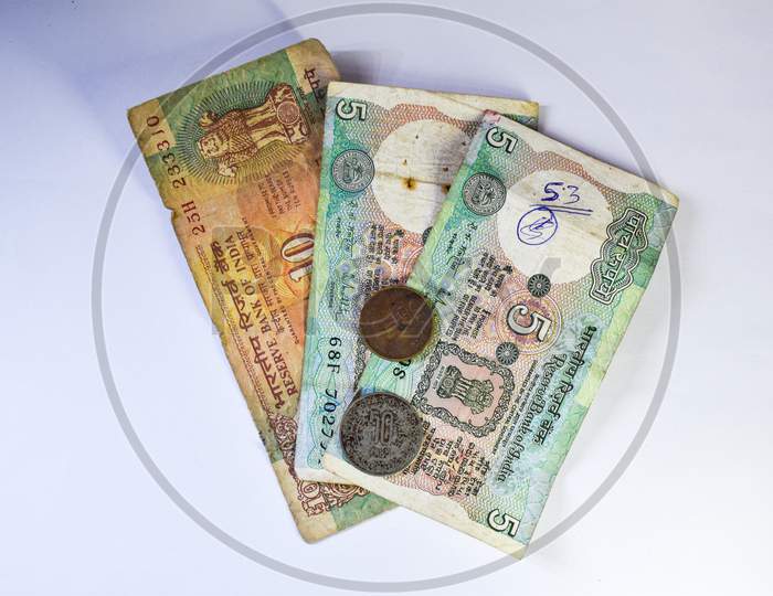 Image Of Old Indian Currency Notes And Coins On White Background.