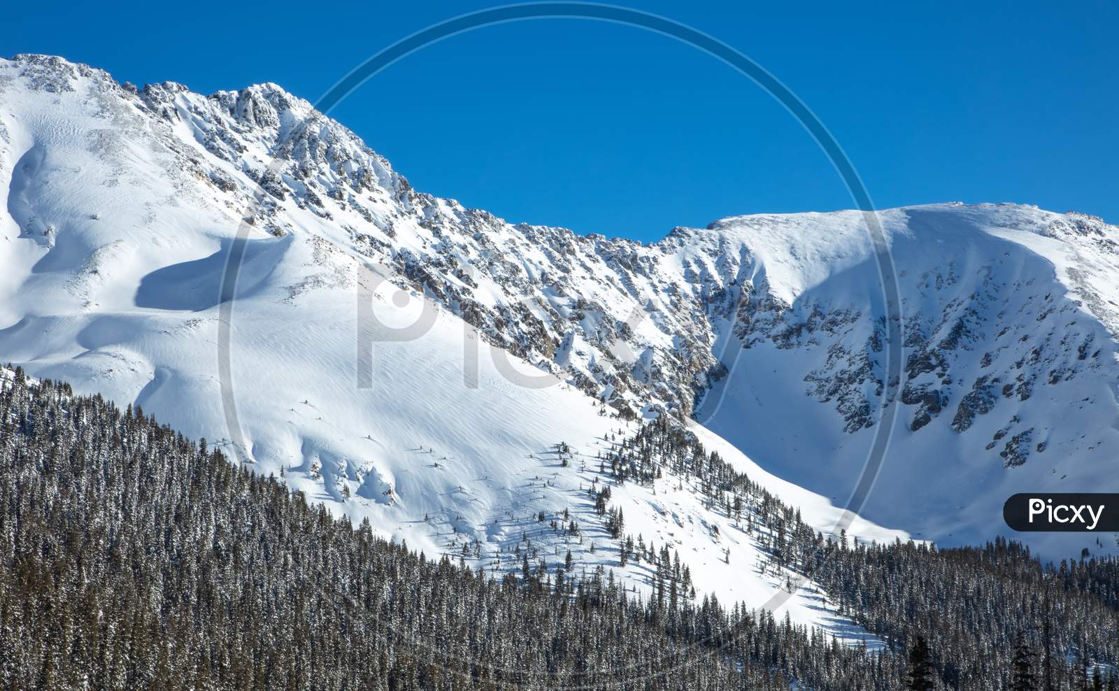 Snow Covered Slopes Of Rocky Mountains