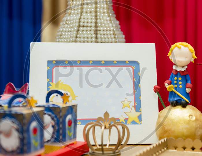 Kids Birthday Party Decoration. Blue Fake Cake With Candle. Little Prince Theme Party. Decorated Table For Child Birthday Celebration. Close Up Of Decor Party.