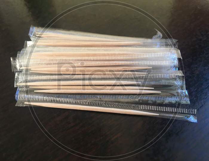 Disposable Wooden Toothpick In Plastic Bag On Wooden Table