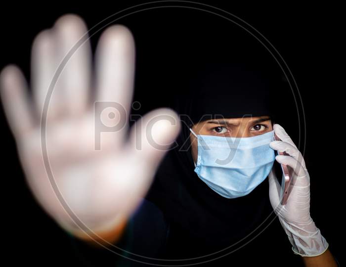 Stop Coronavirus. A Young Asian Woman Wearing A Face Mask And Medical Rubber Gloves. Protest And Focus Shifted Photo.