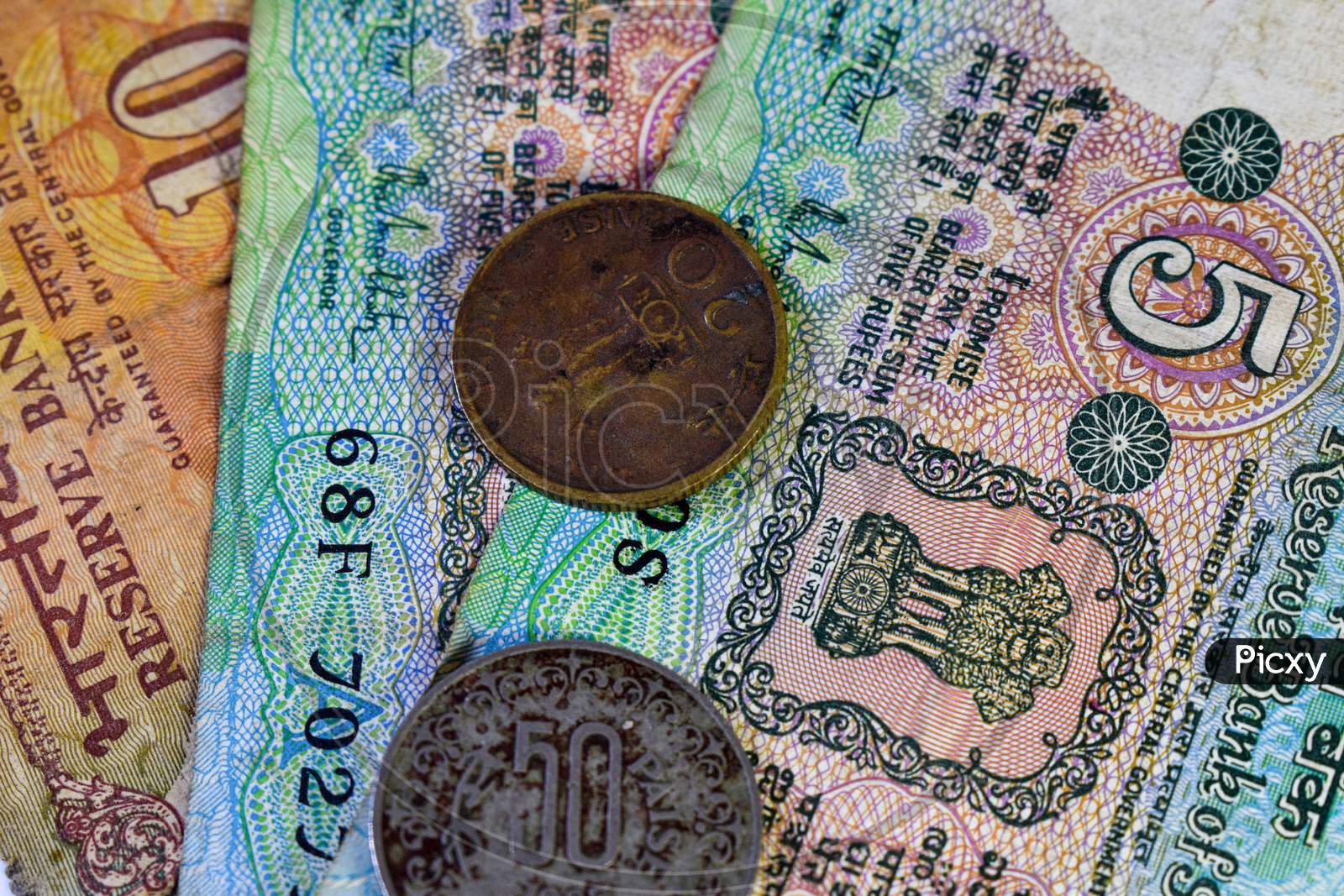 Background Image Of Old Indian Currency Notes And Coins.