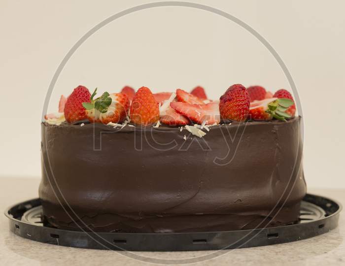 Delicious Chocolate Cake Topped With Many Sliced Strawberries. Party Concept. Selective Focus.