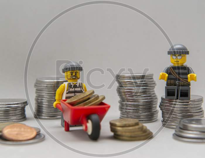 Minifigures Of Bank Robbers Stealing Money. Thieves Carrying Coins