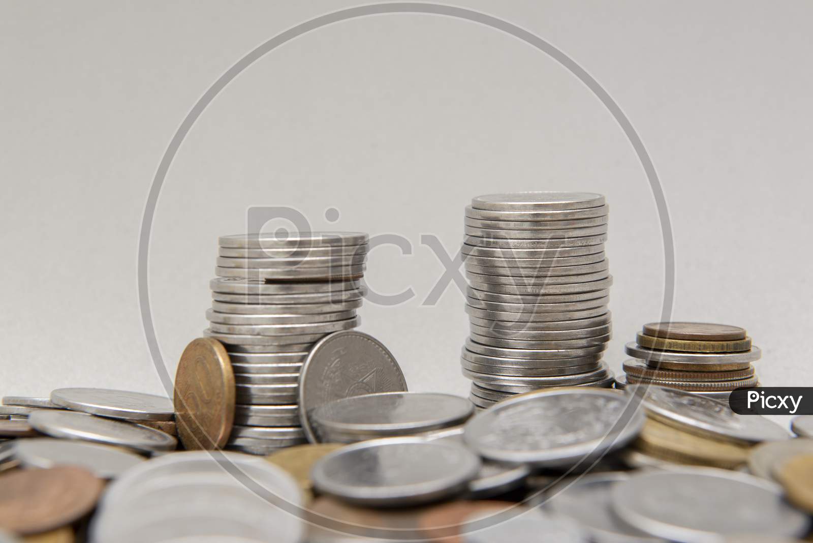 Stack Of Coins With White Background. Selective Focus.